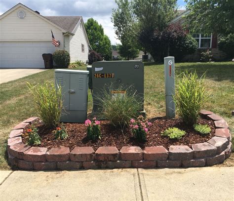 creative way to hide electrical box in yard|hiding utility boxes outdoors.